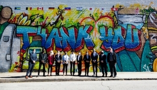 Representatives from nine consulates and the City of Atlanta pose in front of the